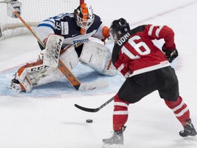 Team Finland goaltender Juuse Saros stops a shot from Max Domi during first period preliminary round hockey action at the IIHF World Junior Championship Monday, December 29, 2014, in Montreal.
