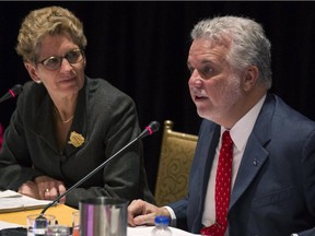 Ontario Premier Kathleen Wynne and Quebec Premier Philippe Couillard chair a joint cabinet meeting at the Ontario Legislature in Toronto on Friday, November 21, 2014.