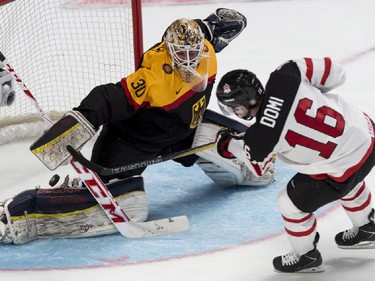 Team Germany goaltender Kevin Reich makes a save off Team Canada's Max Domi during first period preliminary round hockey action at the IIHF World Junior Championship Saturday, December 27, 2014 in Montreal.