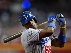 Cuban Yasiel Puig of the Los Angeles Dodgers warms up on deck during game against the Arizona Diamondbacks at Chase Field on July 8, 2013 in Phoenix.