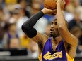 The Los Angeles Lakers' Kobe Bryant shoots a free throw to tie Michael Jordan on the NBA's all-time scoring list during the second quarter of game against the Minnesota Timberwolves on Dec. 14, 2014 at the Target Center in Minneapolis.