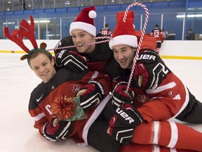Josh Morrissey, left to right, Max Domi and Frederik Gauthier ham it up during a photo shoot in Toronto on Saturday. They're part of Team Canada a the IIHF World Junior Championship, which begins on Friday.