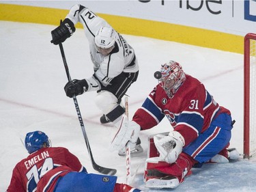 Montreal Canadiens goaltender Carey Price makes a save against Los Angeles Kings' Marian Gaborik (12) as Canadiens' Alexei Emelin defends during first period NHL hockey action in Montreal, Friday, December 12, 2014.