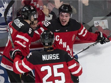 Canada's Max Domi (right) celebrates his goal past USA goaltender Thatcher Demko with teammates Shea Theodore, left, and Darnell Nurse during second period preliminary round hockey action at the IIHF World Junior Championship, Wednesday, December 31, 2014 in Montreal.