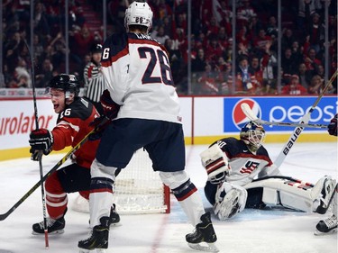 Canada's Max Domi, left, celebrates after scoring his team's first goal on USA's goaltender Thatcher Demko as USA's Brandon Carlo looks on during second period preliminary round hockey action at the IIHF World Junior Championship, Wednesday, December 31, 2014 in Montreal.THE CANADIAN PRESS/Ryan Remiorz