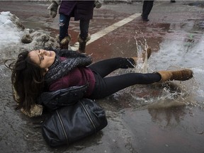 McGill University student Mayumi Louguet falls on a patch of ice created by overnight freezing rain on the corner of McTavish and Sherbrooke Sts. in 2014.