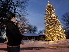 Michelle Frenette and daughter Clara look at a decorated tree at their home on Waverley Ave. in Pointe-Claire on Saturday, Dec. 13, 2014.