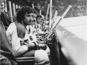 Canadiens defenceman Guy Lapointe sits on bench at the Forum during a 1970s game.