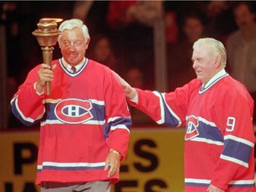 Montreal Canadiens greats Jean Beliveau gets the torch from Maurice "Rocket" Richard (right) during closing ceremonies after final game at the Forum in Montreal Monday March 11, 1996. Former Montreal Canadiens star Jean Beliveau died Tuesday at the age of 83.