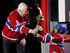 Canadiens legend Jean Béliveau passes torch to a young skater before Game 3  of playoff series against the Boston Bruins at the Bell Centre on April 18, 2011.
