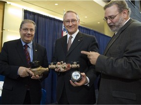 Montreal mayor Gérald Tremblay — flanked by Sammy Forcillo, right, and Yves Provost city manager in charge of infrastructure — show the new water meters at press conference in Montreal in 2007.