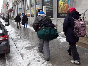 Two men walk away from Accueil Bonnneau on Monday December 02, 2013. Despite the great success of Housing First/Chez Soi program, Montreal will not be adopting this model of reducing homelessness.