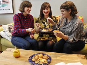 Sydney Warshsaw, left, Kat Romanow and Rebecca Lessard taste test a batch of ricotta latkes. Latkes will be on the menu at a Hanukkah party the three are organizing on Dec. 20.