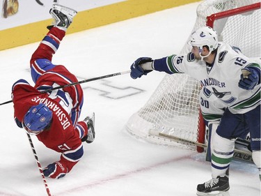 Montreal Canadiens David Desharnais falls after getting caught up with the stick of  Vancouver Canucks Brad Richardson, right, during third period of National Hockey League game in Montreal Tuesday December 09, 2014.