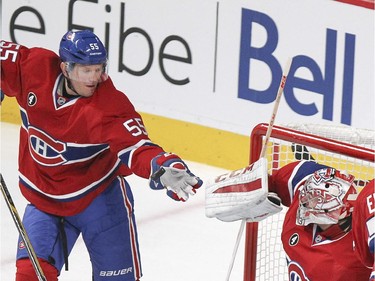 Montreal Canadiens defenceman Sergei Gonchar, left, knocks the puck away from goalie Carey Price during National Hockey League game against the Vancouver Canucks in Montreal Tuesday December 09, 2014.
