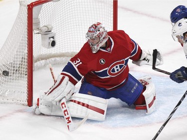 Montreal Canadiens goalie Carey Price steers away a shot as teammate P.K. Subban, rear, ties up Vancouver Canucks Linden Vey during second period of National Hockey League game in Montreal Tuesday December 09, 2014.