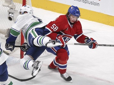 Montreal Canadiens Sven Andrighetto, right, collides with Vancouver Canucks Yannick Weber during third period of National Hockey League game in Montreal Tuesday December 09, 2014.
