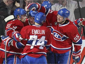 Montreal Canadiens Tomas Plekanec, left, celebrates his game-winning goal against the Vancouver Canucks with teammates Sven Andrighetto, rear, Alexei Emlin and Sergei Gonchar during third period of National Hockey League game in Montreal Tuesday December 09, 2014.
