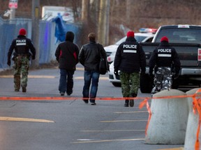 MONTREAL, QUE.: DECEMBER 1, 2014--  Montreal police fan out as the walk the perimeter around the Bistro XO Plus in Montreal on Monday December 1, 2014. The Bistro was the sight of a mafia related slaying.(Allen McInnis / MONTREAL GAZETTE)