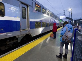 Passengers get ready to board the second train of the morning from Mascouche at the Ahuntsic station in Montreal Dec. 1, 2014.