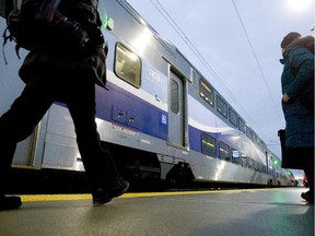 Passengers get ready to board the second train of the morning from Mascouche at the Ahuntsic station in Montreal, Monday December 1, 2014.