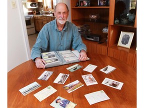 Victor Breedon with a selection of his postcards from the early 20th century at his home in Roxboro.