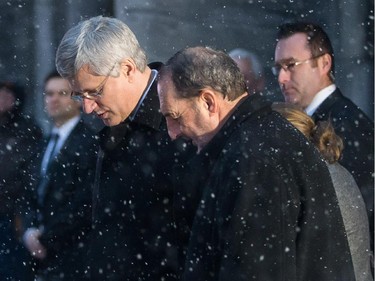 Canadian Prime Minister Stephen Harper, left, leaves the funeral for Montreal Canadiens hockey great Jean Béliveau with Intergovernmental Affairs Minister Denis Lebel, right, at the Mary Queen of the World Cathedral in Montreal on Wednesday, December 10, 2014.