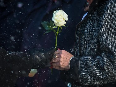 Daughter of hockey great Jean Béliveau, Helene, right, receives a white rose at the end of the funeral of the former Montreal Canadiens captains at the Mary Queen of the World Cathedral in Montreal on Wednesday, December 10, 2014.