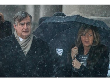 Former Quebec Premier Lucien Bouchard, left, and Solange Dugas, right, leave the funeral for Montreal Canadiens hockey great Jean Béliveau at the Mary Queen of the World Cathedral in Montreal on Wednesday, December 10, 2014.