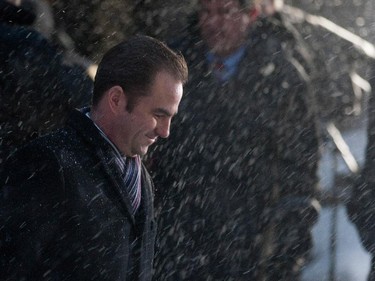 Montreal Canadiens owner Geoff Molson grimaces as he is caught in blowing snow as he leaves Mary Queen of the World Cathedral after the funeral for Montreal Canadiens legend Jean Béliveau in Montreal on Wednesday December 10, 2014.