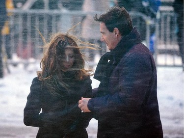 Parti Quebecois MNA Pierre-Karl Péladeau, right, and Julie Snyder, left, leave the funeral for Montreal Canadiens hockey great Jean Béliveau at the Mary Queen of the World Cathedral in Montreal on Wednesday, December 10, 2014.