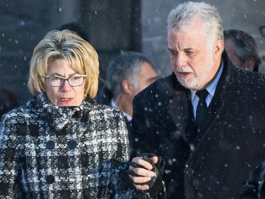 Quebec Premier Philippe Couillard, right, and wife Suzanne Pilote, left, leave the funeral for Montreal Canadiens hockey great Jean Béliveau at the Mary Queen of the World Cathedral in Montreal on Wednesday, December 10, 2014.