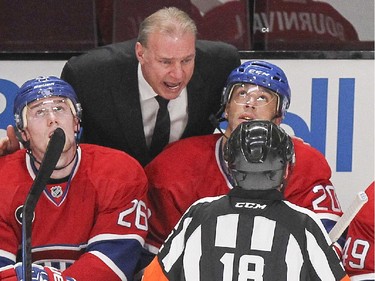 Montreal Canadiens coach Michel Therrien yells at referee Greg Kimmerley after no penalty was called when P.A. Parenteau took a high stick from a Los Angeles Kings player during first period of National Hockey League game in Montreal Friday December 12, 2014.