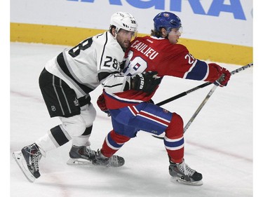 Montreal Canadiens defenceman Nathan Beaulieu, right, holds off Los Angeles Kings Jarret Stoll during first period of National Hockey League game in Montreal Friday December 12, 2014.