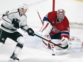 Montreal Canadiens goalie Carey Price lifts the stick of Los Angeles Kings Tanner Pearson as he makes a save during first period of National Hockey League game in Montreal Friday December 12, 2014.