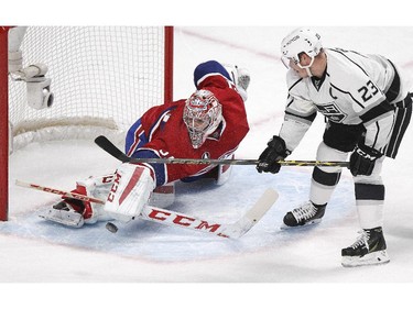 Montreal Canadiens goalie Carey Price makes a save as Los Angeles Kings Dustin Brown looks for a rebound during second period of National Hockey League game in Montreal Friday December 12, 2014.