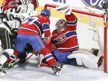 Montreal Canadiens goalie Carey Price does the splits to block the net while teammate Max Pacioretty holds off Los Angeles Kings Kyle Clifford and Revor Lewis during National Hockey League game in Montreal Friday December 12, 2014.