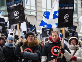 People gather to protest against austerity measures outside the Sheraton hotel in Montreal where Quebec Treasury board president Martin Coiteux was speaking on Friday, December 12, 2014.