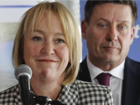 In this file picture from December of 2014, Longueuil mayor Caroline St. Hilaire, left, smiles while answering questions at with  Municipal Affairs Minister Pierre Moreau, right . The photograph was taken at the height of a public feud between the two over provincial funding of municipalities. (Marie-France Coallier / Montreal Gazette)