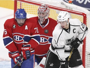 The puck deflects off Montreal Canadiens defenceman P.K. Subban defending against Los Angeles Kings Dustin Brown in front of goalie Carey Price during third period of National Hockey League game in Montreal Friday December 12, 2014.