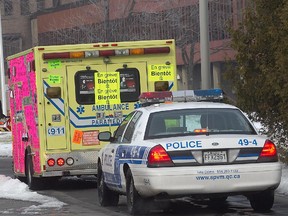 A police car follows an ambulance in Montreal.