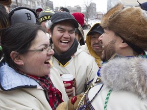 Youth Grand Chief Joshua Iserhoff, right, shares a laugh with Marie-Anne Jolly, left, and Nick Wapachee, in Montreal Dec. 15, 2014. Members of the Cree nation had just completed an 800-km walk from Mistissini to Montreal to protest against uranium mining in Quebec.