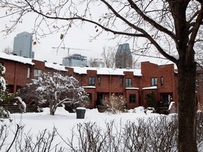 Residents of a small enclave of townhouses built on the former the CN rail tracks that once ran along side Notre-Dame street have donated food supplies to volunteers Darrell Helyar, and Eddie Nurse, not seen, for their Christmas food drive benefiting Little Burgundy in Montreal on Tuesday December 16, 2014.