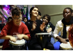 Students with play djembes during a Christmas concert at École Irenée Lussier.