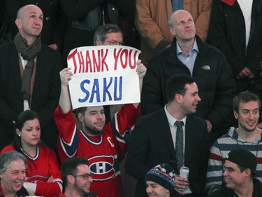 A fan holds a sign in the stands during ceremony for former Montreal Canadiens captain Saku Koivu prior to National Hockey League game between the Habs and the Anaheim Ducks in Montreal Thursday December 18, 2014.
