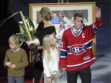 Former Montreal Canadiens captain Saku Koivu, with son Aatos, wife Hanna and daughter Ilona acknowledges ovation from fans during ceremony prior to National Hockey League game between the Habs and the Anaheim Ducks in Montreal Thursday December 18, 2014.