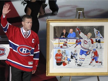 Former Montreal Canadiens captain Saku Koivu acknowledges ovation from fans during ceremony prior to National Hockey League game between the Habs and the Anaheim Ducks in Montreal Thursday December 18, 2014 where he was presented with a painting commemorating his career with the team.