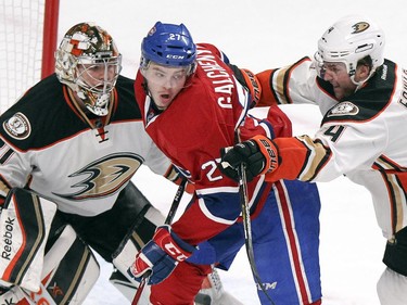Montreal Canadiens Alex Galchenyuk gets cross-checked by Anaheim Ducks Cam Fowler in front of goalie Frederik Andersen during first period of National Hockey League in Montreal Thursday December 18, 2014.