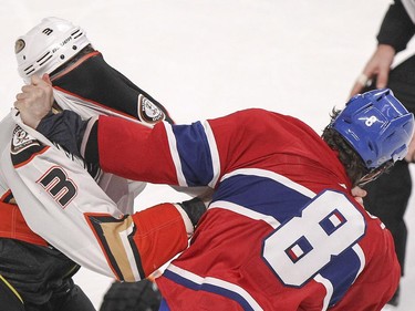 Montreal Canadiens Brandon Prust, right, pulls Anaheim Ducks Clayton Stoner's jersey up over his face during fight in the third period of National Hockey League game in Montreal Thursday December 18, 2014.