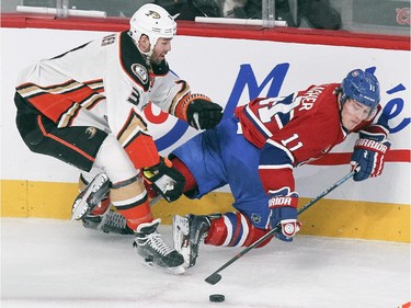 Montreal Canadiens Brendan Gallagher, right, is checked from behind by Anaheim Ducks Clayton Stoner during first period of National Hockey League in Montreal Thursday December 18, 2014.